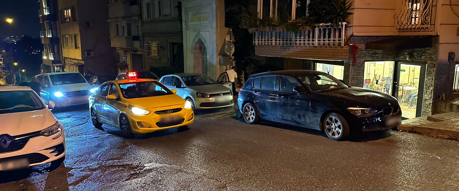 At night, a yellow Istanbul taxi with a red light, meaning it's full.